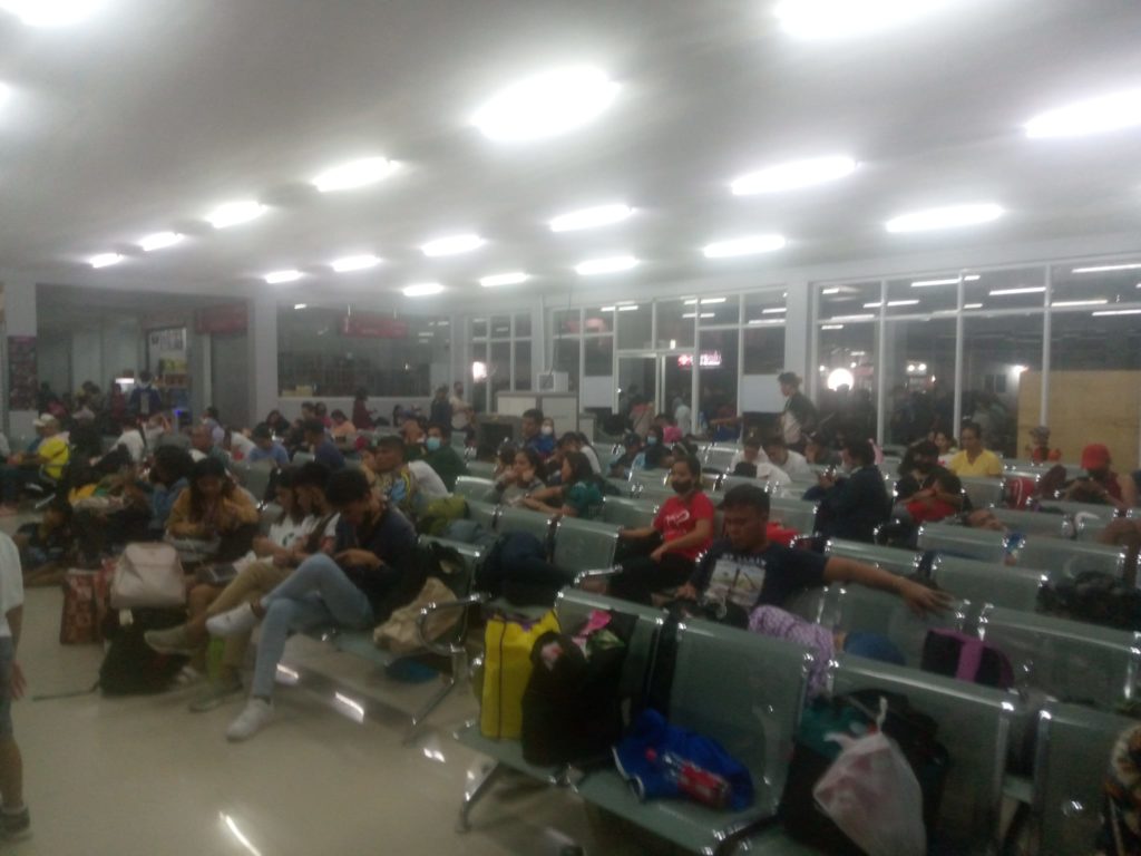Photo of people crowding the passenger terminal at the Hagnaya Port in San Remegio town for story: Hundreds remain stranded in Cebu ports due to bad weather