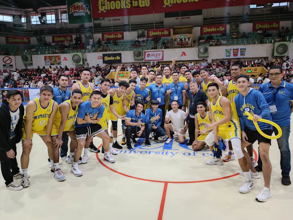 The UC Webmasters players and coaching staff take time for a photo shoot as they savor their victory against USP-F and former’s first trip to the Cesafi men’s basketball finals. | Glendale G. Rosal
