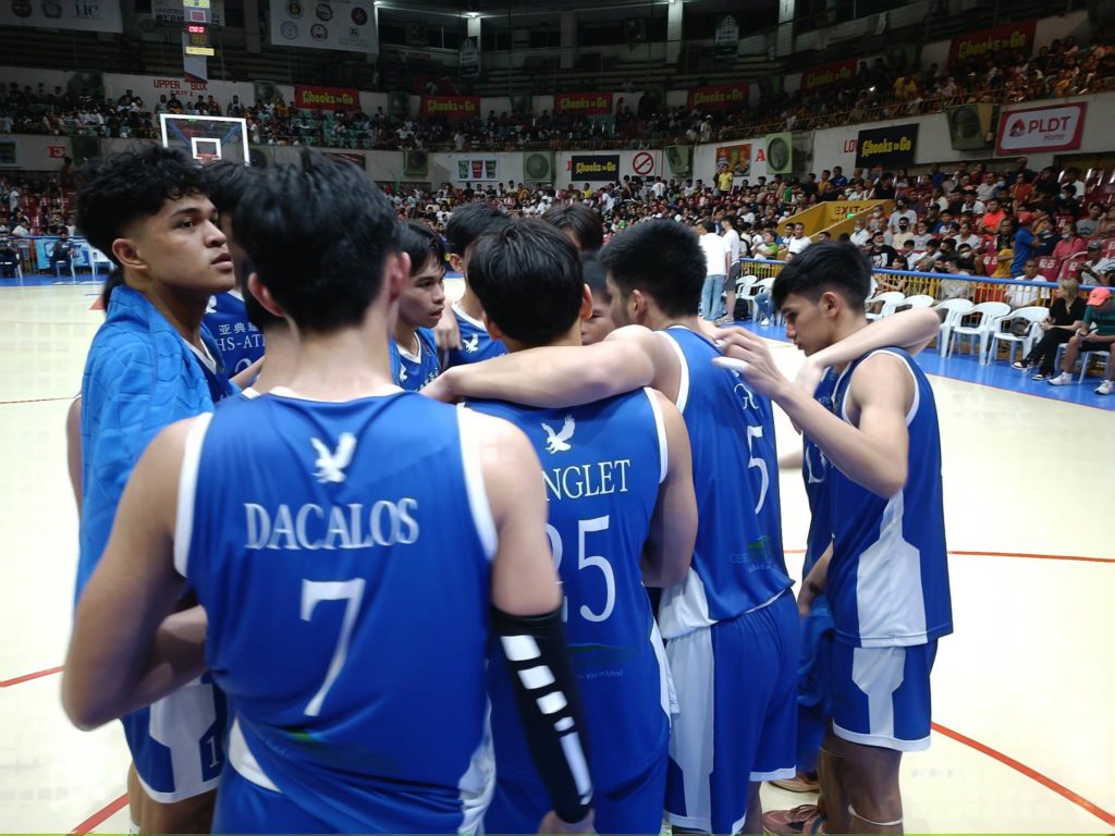 SHS-AdC Magis Eagles players huddle up after beating CBSAA in Game 1 of their best-of-three finals series in the Cesafi finals. | Glendale Rosal