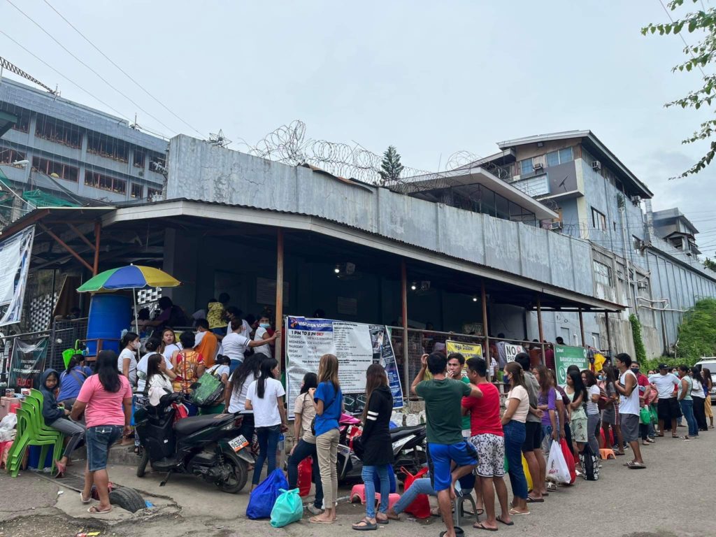 Visitors line up outside of the Cebu City Jail Male Dormitory.