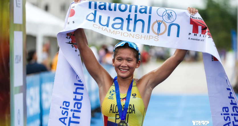 Raven Faith Alcoseba raises the finish line tape after topping the women's elite sprint distance of the National Duathlon Championships in Tarlac. | Photo from the National Duathlon Championships Facebook page