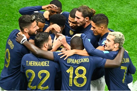 France’s players celebrate scoring their first goal during the Qatar 2022 World Cup quarter-final football match between England and France at the Al-Bayt Stadium in Al Khor, north of Doha, on December 10, 2022. (Photo by Jewel SAMAD / AFP)