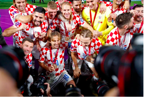 Croatia’s Luka Modric and teammates celebrate with their medals as they finish in third place in the FIFA World Cup at the Khalifa International Stadium in Doha, Qatar. (REUTERS)