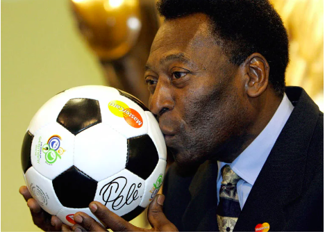 In this file photo taken on December 08, 2005, Brazilian football legend Pele kisses a ball, during a presentation in Leipzig on the eve of the final draw of the Fifa football World Cup 2006. – The hospital treating Brazilian football great Pele announced on December 21, 2022, a “progression” in his cancer, as well as kidney and heart “dysfunctions.” Pele, 82, is being treated in the general ward but “requires greater care related to renal and cardiac dysfunctions,” said the Albert Einstein Hospital in Sao Paulo. (Photo by Franck FIFE / AFP)