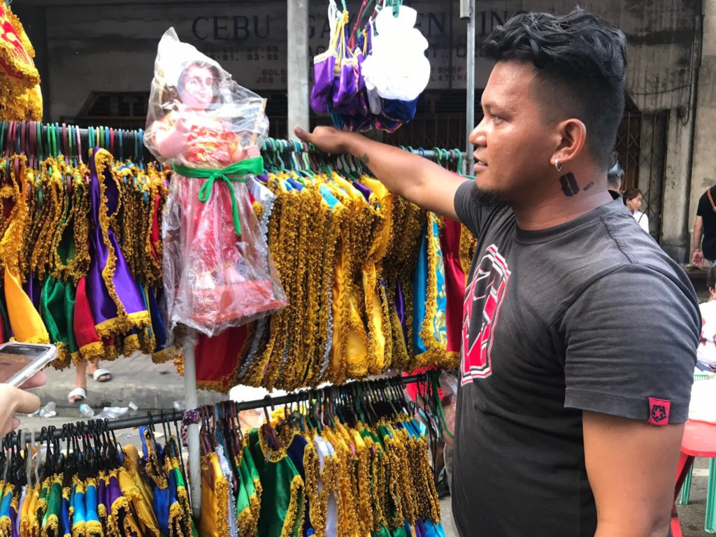 Pampanga-native Jefferson Mercado sells Sto. Niño clothes and costumes outside the Basilica. | Contributed photo