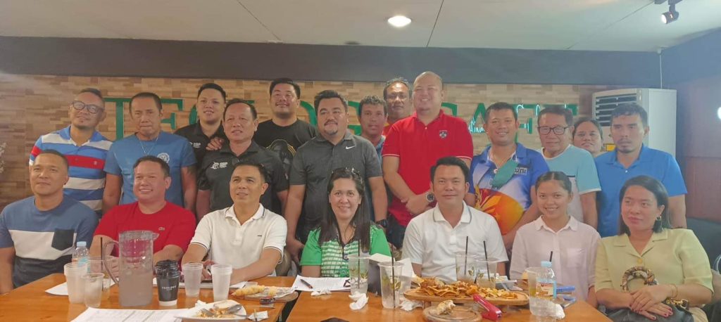 Minglanilla Archangels head coach Boyet Velez (seated third from left in white shirt) joins the coaches and officials of the Cong. Rhea Gullas Cup in a meeting last Thursday. | Photo from the Cong. Rhea Gullas Cup Facebook photo.