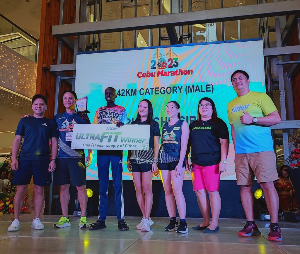 Eric Chipsiror (holding a trophy) is the winner of the men's category of the 42K Cebu City Marathon.. | Glendale Rosal