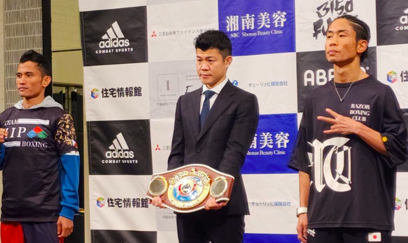 Melvin Jerusalem (left) and Masataka Taniguchi (right) flanks a Japanese boxing official holding the WBO world minimumweight title during the official weigh-in for their world title duel. | Photo from Sanman Boxing Facebook page