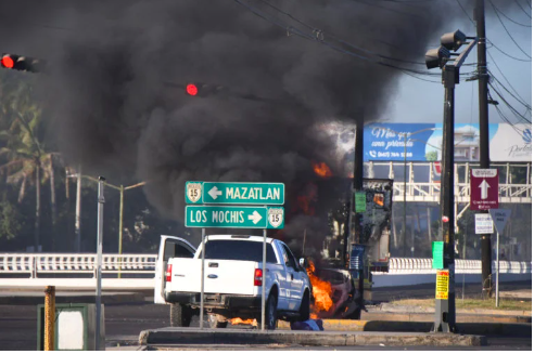 Burning vehicles are seen blocking a road after drug lord Ovidio Guzman’s capture, in Culiacan, Sinaloa, Mexico, on January 5, 2023. Revista Espejo/Leo Espinoza/Handout via REUTERS