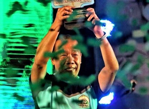 Ricky Ballesteros lifts the National Milo Little Olympics trophy. | From Ballesteros' Facebook page
