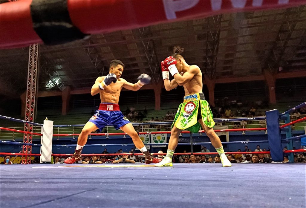 Regie Suganob (left) throws a jab while Mark Vicelles defends himself in their IBF world light flyweight title eliminator in Calape, Bohol, on Saturday evening. | Glendale Rosal