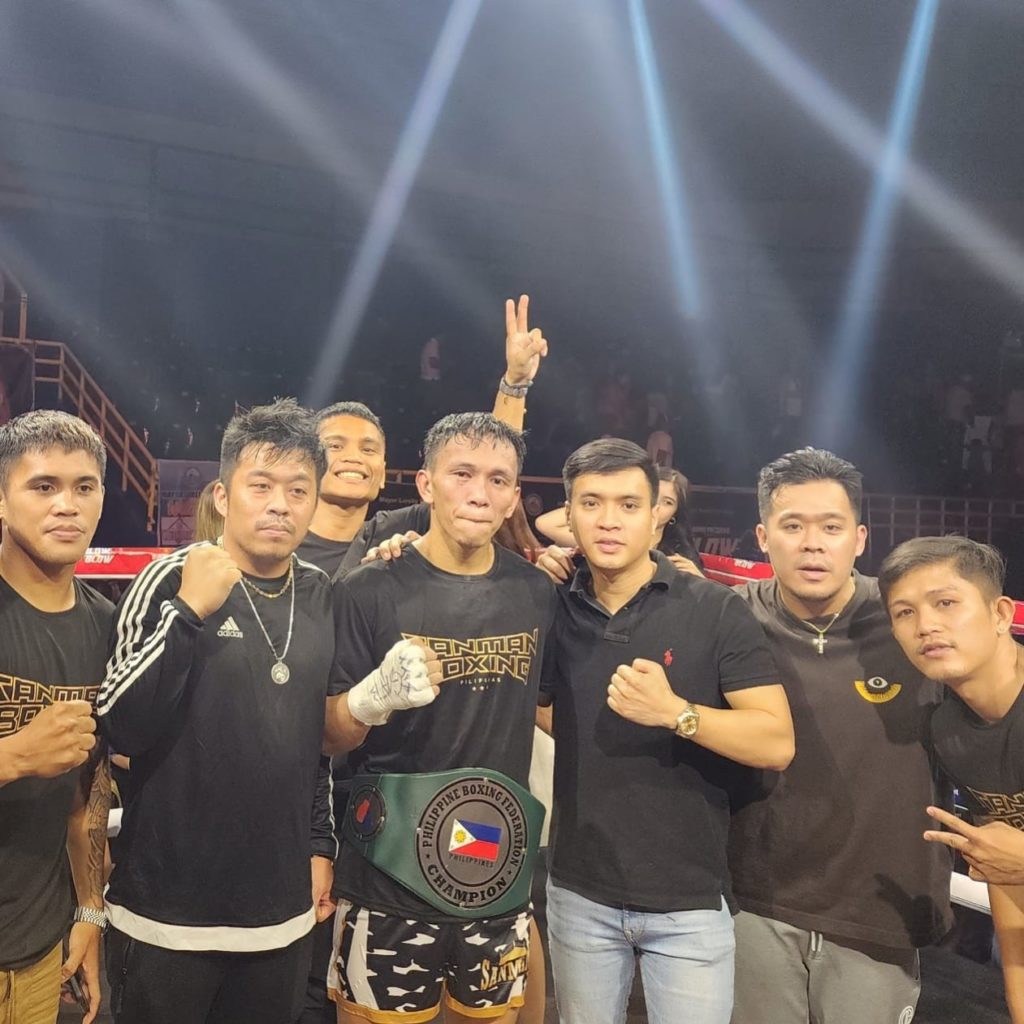 Presco Carcosia with the PBF belt around his waist celebrates with his managers from Sanman Boxing Team after beating Arnel Baconaje last Sunday evening in General Santos City. | Photo from Sanman Boxing's Facebook page