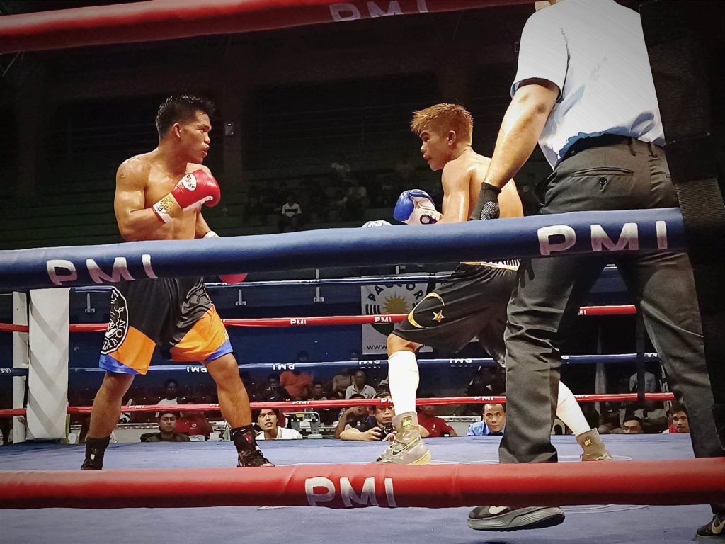 Jess Rhey Waminal (right) beats Jhunriel Castino (left) during their eight-round bout and prevent a sweep of the PMI Bohol Boxing Stable boxers in “Kumong Bol-anon 9: Tribute to Maestro.”
