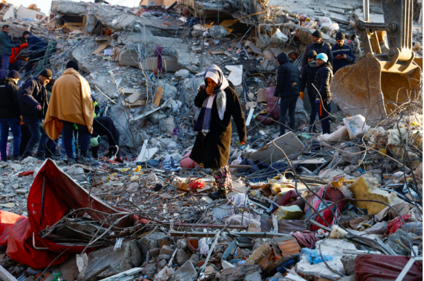 FILE PHOTO: A woman looks at the destruction following an earthquake in Kahramanmaras, Turkey, February 8, 2023. REUTERS/Suhaib Salem