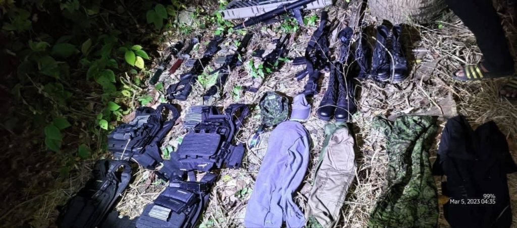 The high powered firearms and combat uniforms that were recovered in a plantation in Bayawan City for story: One of the suspects in Gov Roel Degamo's murder killed in firefight with authorities