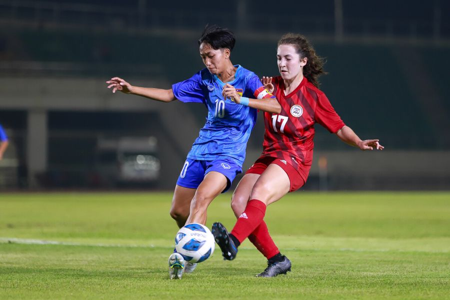 Isabella Flannigan (in red jersey) of the Philippines fights for possession against a player from Laos in their AFC U20 Asian Women's Championship Qualifiers.