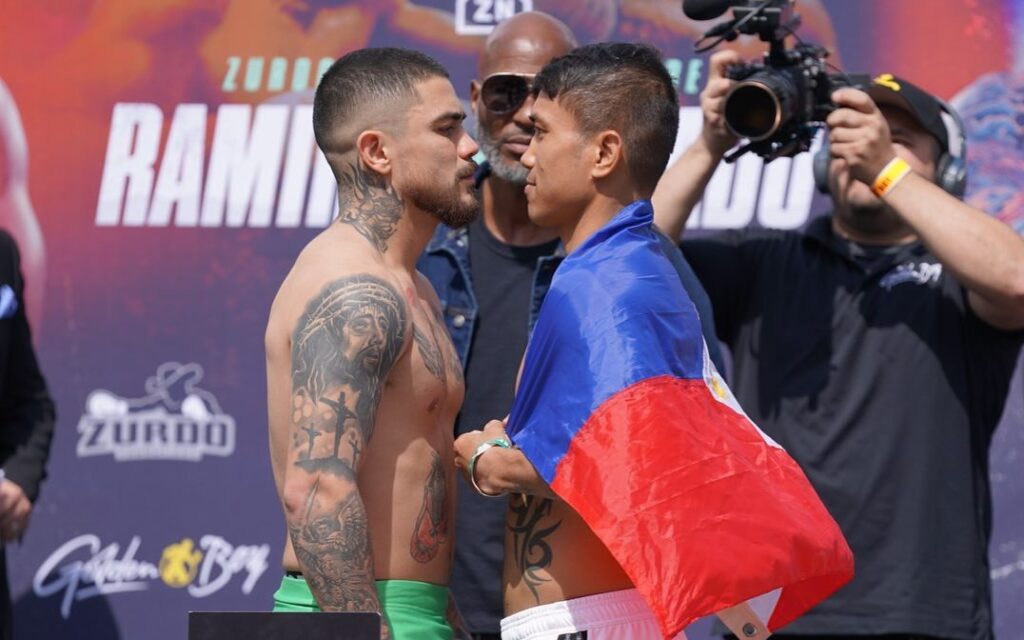 Joseph Diaz (left) and Mercito Gesta (right) engage in a stare down after passing the weigh-in for their 12-rounder bout in Long Beach, California.