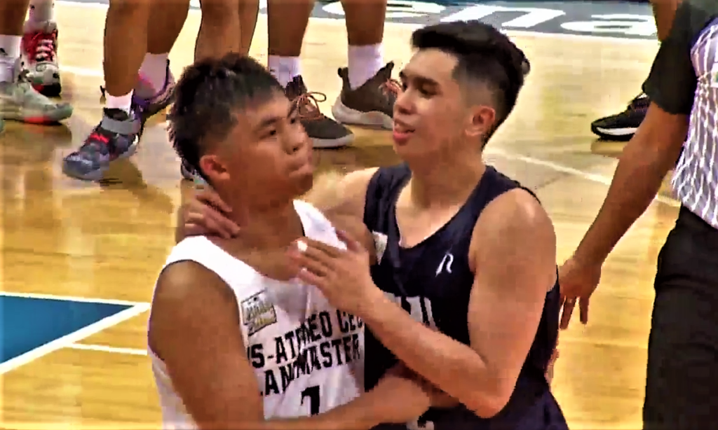 Reinhard Jumamoy (dark jersey) of the NU-Nazareth Bullpups comforts fellow Cebuano Jared Bahay (white jersey) after they defeated the latter and the SHS-AdC Magis Eagles-Cebu Landmasters in the semifinals of the NBTC National Finals Division 1.