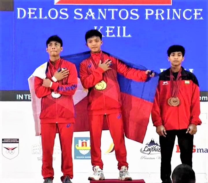 Eron Borres (left) joins Prince Keil Delos Santos (top of the podium) during the awarding ceremony in the men's 49kg category of the IWF Youth World Championships in Albania. Joining them is Dhanush Loganathan of India (right). | Photo from Ramon Solis