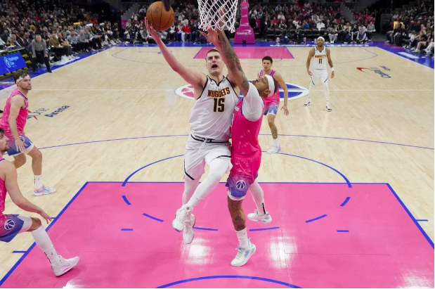Nikola Jokic #15 of the Denver Nuggets goes up against Daniel Gafford #21 of the Washington Wizards during the second half at Capital One Arena on March 22, 2023 in Washington, DC. Jess Rapfogel/Getty Images/AFP
