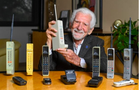 Engineer Martin Cooper holds a contemporary copy of the original cell phone he used to make the first cell phone call on April 3, 1973, in Del Mar, California on March 20, 2023. The problem with mobile phones is that people look at them too much. At least, that’s according to the man who invented them 50 years ago. Martin Cooper, an American engineer dubbed the “Father of the cell phone,” says the neat little device we all have in our pockets has almost boundless potential and could one day even help conquer disease. But right now, we can be a little obssessed. (Photo by VALERIE MACON / AFP)