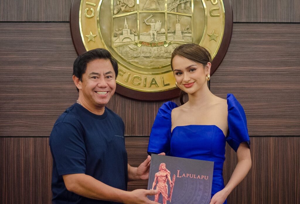Lapu-Lapu City Mayor Junard Chan meets with Claire Inso and gives her a book about their local hero, Datu Lapulapu.