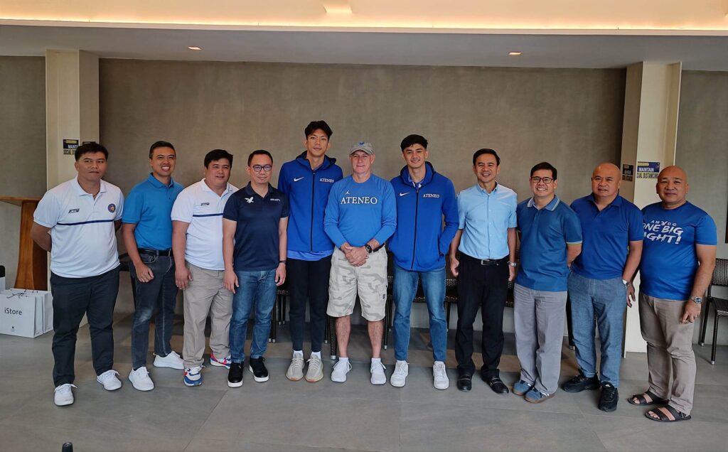 Raffy Celis (fifth from left) and Michael Asoro (fifth from right) join Ateneo Blue Eagles head coach Tab Baldwin (center) and the SHS-AdC Magis Eagles sports and school officials in a presser on Monday, April 10, in Mandaue City.