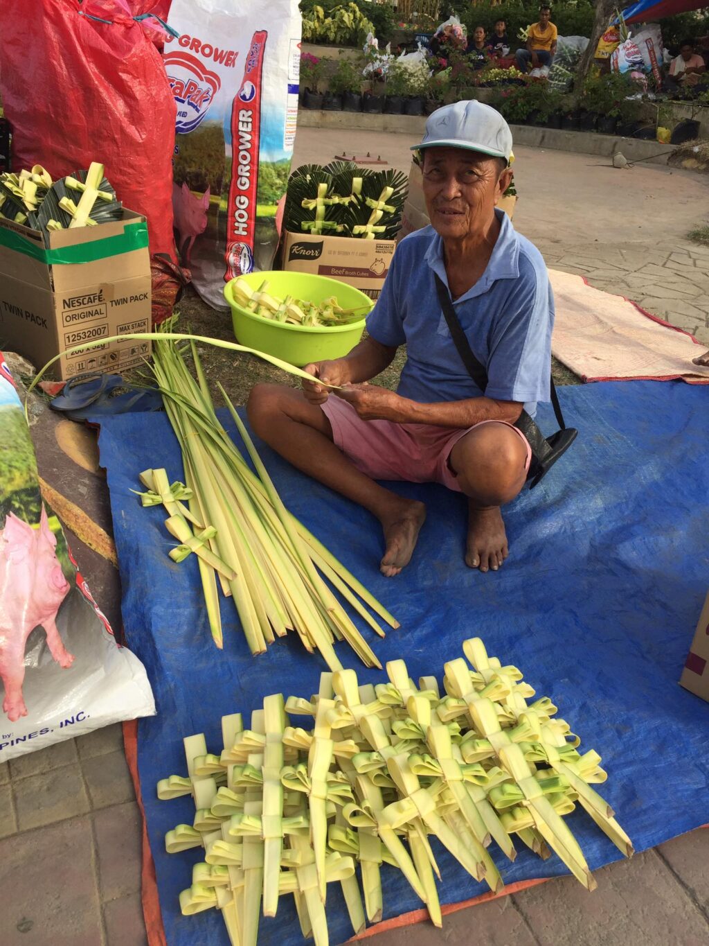 Vendors look forward to improved sales this Palm Sunday. Nasing Lobiano of Tabogon town in northern Cebu says he and his wife arrive at dawn today, April 1, in Mandaue City to prepare their palm fronds for the churchgoers tomorrow, which is Palm Sunday. | Doris Bongcac