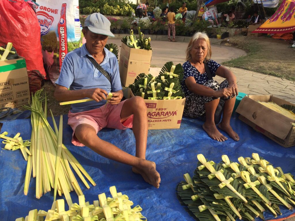 Vendors look forward to improved sales this Palm Sunday. Couple Nasing Lobiano, 71, and Anecita Lobiano, 70, hope that they will have better sales of crosses made of palm fronds on Palm Sunday tomorrow, April2. | Doris Bongcac