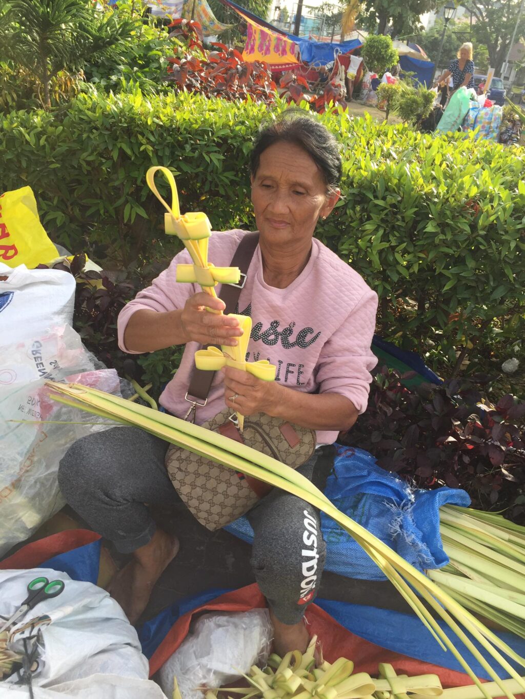 Vendors look forward to improved sales this Palm Sunday. Emily Waper, 62, of Carcar City also hopes to have better sales, which will be enough to cover her expenses to get here to sell her palm fronds. | Doris Bongcac