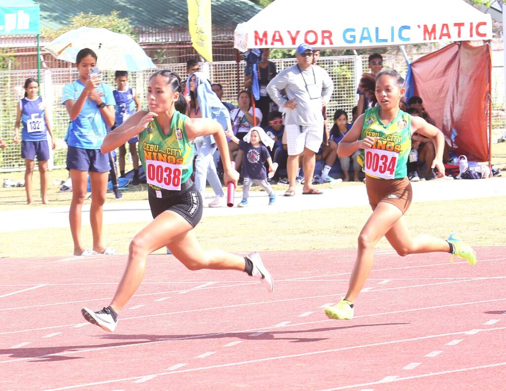 CEBU CITY, Philippines — Team Cebu City Niños hauled 22 gold medals in the penultimate day of the Central Visayas Regional Athletic Association (CVIRAA) in Carcar City on Thursday, April 27, 2023. One of its delegation heads, Francis Ramirez of the Cebu City Local Schools Board believes that they will emerge on top of overall medal tally as the meet wraps up tomorrow. The Cebu City Niños, the perennial overall champions of CVIRAA, finished with 78 gold, 60 silver, and 76 bronze medals in the 2019 edition in Dumaguete City. Fast forward to 2023 after the COVID-19 pandemic, the Niños are eyeing to extend its reign in this meet that serves as the qualifiers for the Palarong Pambansa. Ramirez told CDN Digital that their official medal tabulator for Cebu City have already tallied 75 gilts, which is less than three gold medals from its 2019 haul. However, the Department of Education (DepEd) Region VII has yet to release its partial and official medal tally as of this writing. They are expecting more gold medals tomorrow as most of its team events have already secured a spot in the gold medal round tomorrow, while some individual events are still happening as of press time. The Niños are able to deliver a convincing performance despite the lukewarm performances from its athletes due to the hastened preparation for the meet. "Sa karon, affected gyud atong performance. Mao kinahanglan morecover ta bisan naglead ta. Maningkamot ta especially sa elementary. Dili ingon kulelat, pero weak kaayo atong elementary unlike sa secondary division," said Ramirez. (For now, our performance has been affected. That is why we need to recover even though we are leading (in the medal tally). We will try our best especially in our elementary. It is not that we are really zero or that low but our elementary is really weak unlike the secondary division.) The Niños only had roughly two weeks to train for CVIRAA after the Cebu City Olympics was held earlier this month. "Ang uban divisions pud na pick up na sama sa Bayawan. Para namo mao ni wake up call sa Cebu City para mas prepared pa sa sunod CVIRAA,” Ramirez said. (Our other divisions had been picked up same as Bayawan. For us, this is a wake up call for Cebu City for us to be prepared in the next CVIRAA.) “After man gud sa Cebu City Olympics, diretso na mi og training kay wala nay oras. Mao nang wala pay recovery ang mga bata nagtraining na gikan sa City Olympics. Usa na sa factor nga duol kaayo atong training camp sa CVIRAA,” he said. (After the Cebu City Olympics, we went straight to training because we did not have enough time. That is why the kids have no recovery (time) because they came from City Olympics. That is one factor that our training camp in CVIRAA is very close (to the event).) Nonetheless, Ramirez lauded the Niños' determination despite the tough competition and the blistering summer heat. A testament to this are the 22 gold medals the Niños' bagged in the penultimate day of CVIRAA on Thursday, April 27. The bulk of the Niños' gold medals came from its archers, who bagged seven of them, and its swimmers who harvested eight gilts. These archers are Aldrener Igot (secondary boys 60-meter, 70m, and FITA round), Zyril Jamse Fano (Stem A boys 30m and Olympic round). Igot and Fano teamed up with Kien Zhyron Torreon and Lawrence Ren Degamo to bag the gold medal in the secondary boys team trio boys. Joining them in winning the gold is its team trio girls comprised of Niña Mae Khylie R. Delos Reyes, Ana May, Generalao, Elizah Viah H. Abbari, and Nikki, Gerondio. All these archers are from the Don Carlos A. Gothong Memorial National High School. Meanwhile, Cebu City's gold medalists in swimming on Thursday were Mike Gabrielle Dela Serna (secondary boys 400m Individual Medley and 50m backstroke), Andrei Valencia (secondary boys 100m butterfly), Em-ji Mata (secondary boys 100m breaststroke), Dionifel Kate Ricarte (secondary girls 100m butterfly), Mary Pauline Indaya (secondary girls 100m breaststroke), and Keziah Denis Sostinto (50m backstroke). They also topped the 4x100m freestyle relay secondary boys comprised of Benedict James Orio, Mata, Dela Serna, and Valencia. In table tennis, Cebu City clinched three gold medals courtesy of Rafael David and Gabriel David Misa who lorded the secondary boys doubles, Andrei Caballes in the singles secondary boys, and Kristien Kaye Alicaya for singles secondary girls. All four athletes are from University of Cebu (UC). In athletics, Juliana Mier Loberanis shone in the secondary girls high jump, while its 4x100m relay secondary girls squad comprised of Leica Lanticse, Shanily Niervez, and Amber Tutor finished first. In the basketball girls, the reigning Batang Pilipino Basketball League (BPBL) National Finals champions, Abellana National School crushed Dumaguete City, 81-30, to rule the secondary girls 5-on-5 basketball. Nadine Labay was named "Most Valuable Player" after erupting for 24 points. Lastly, in boxing, Binjamar Codoy took home the gold medal in the after winning against a pug from Cebu Province in the 52-54-kilogram youth category. Meanwhile, Cebu province pocketed six gilts. Five of them came from its tracksters. Its gold medalists are James Riel Gulfan (110m hurdles and 400m hurdles elementary boys), Jamaica Punay (100m hurdles secondary girls), Kharis Lark Reil Pantonial (400m secondary boys). They also ruled the 4x100m relay secondary boys. Also, Cebu Province got a gold in the table tennis secondary girls. Niño sprinters show the way to victory during the CVIRAA track and field competition at the Carcar City Sports Complex. | Contributed photo