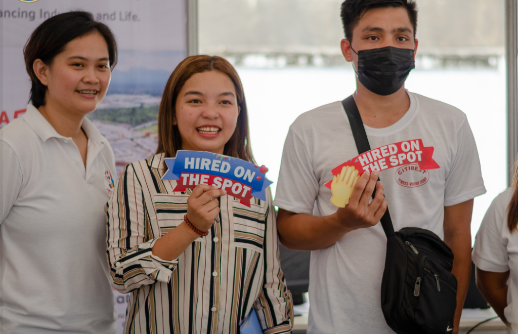 A female applicant in striped blouse (center) and a male applicant in white T-shirt got hired on the spot during the Kadaugan Job Fair on April 14, 2023, held at The Outlet in Pueblo Verde, Barangay Basak, Lapu-Lapu City.