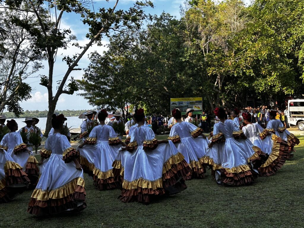 Dancers in white and gold dresses greet visitors of the Suroy Suroy Sugbo Camotes leg when they arrive in one of the island's tourist destinations -- Lake Danao. | Wenilyn Sabalo