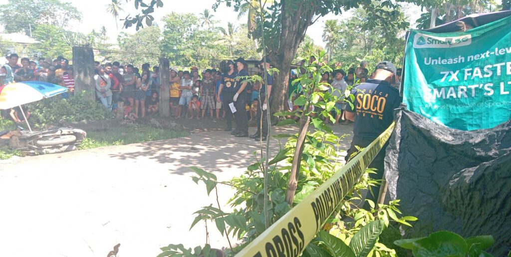 Members of the Scene of the Crime Operatives (SOCO) process the crime scene where Alfonso Buot Jr. was shot dead by an unidentified motorcycle riding gunman in a barangay in Balamban town this morning, April 22. | Paul Lauro 