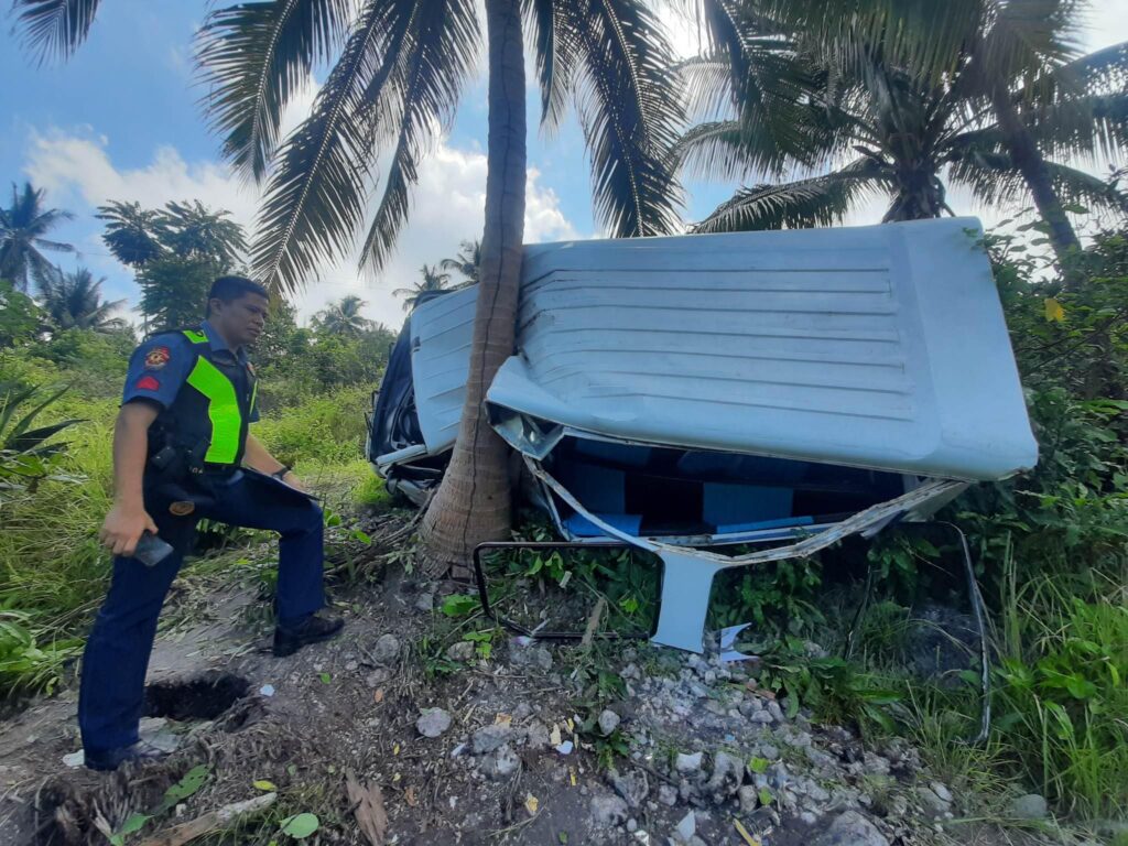 A multicab that overshot and fell two meters at the side of the ravine when it landed on the trunk of a coconut tree in Samboan town southern Cebu. | Photo courtesy of the Samboan Police Staion 