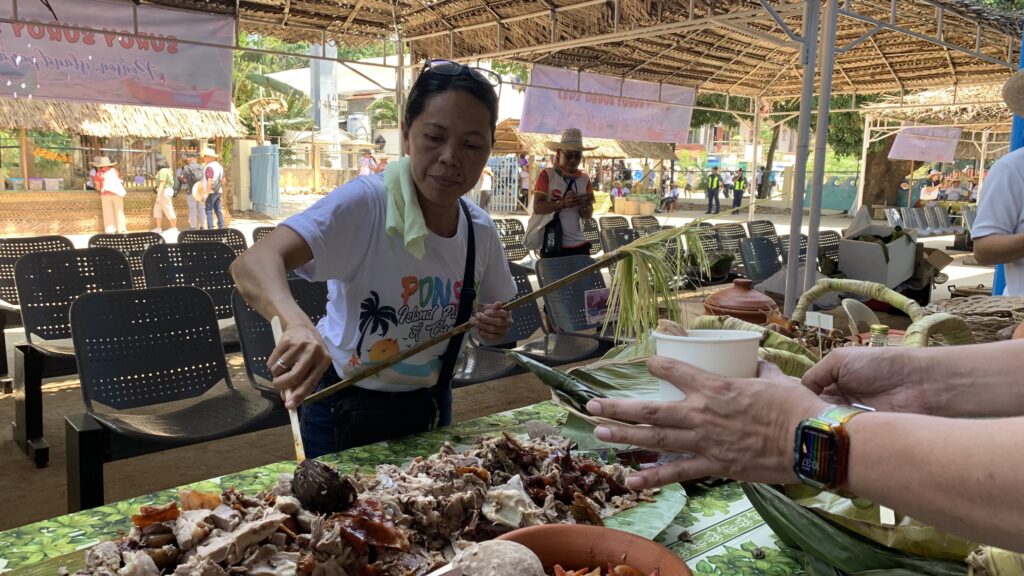 A food server distributed chopped lechon to participants of Suroy Suroy Sugbo in Camotes Island. 