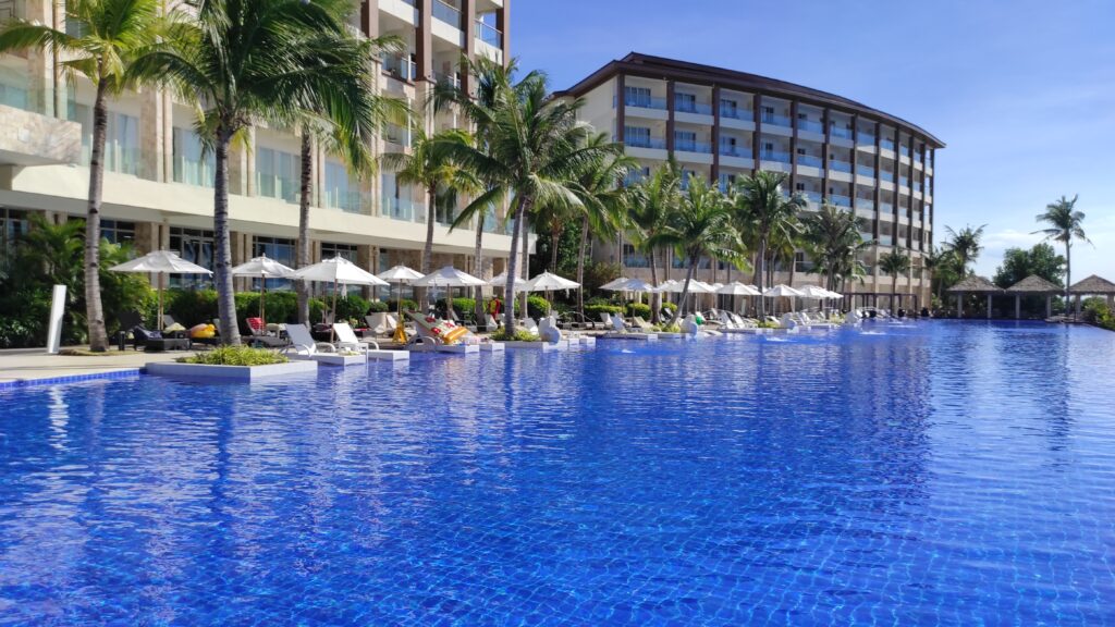 Dusit Thani Mactan Cebu Resort with its magnificent swimming pool and facade on a clear sunny day