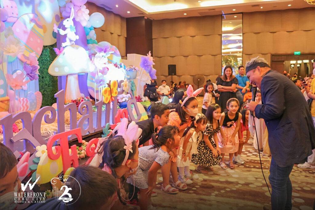 Event host warming up the children participating in the Easter Egg Hunt of Waterfront Cebu City Hotel and Casino