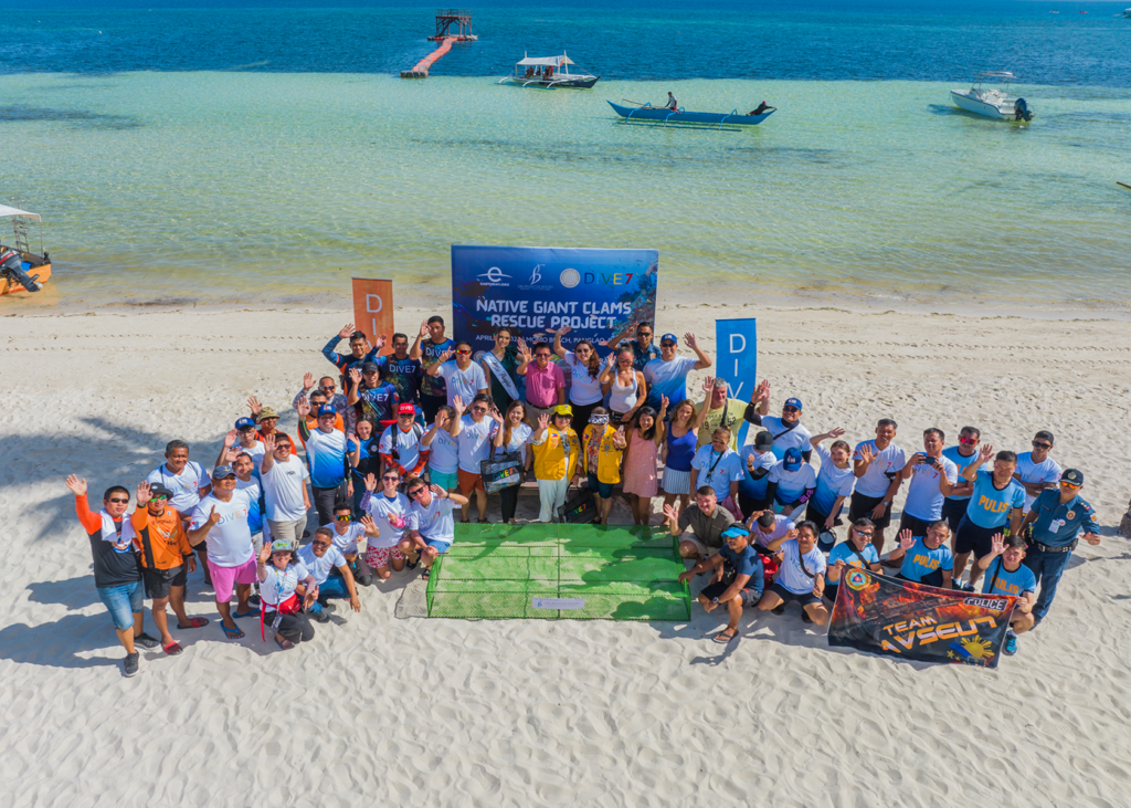 Bellevue Resort staff, partners, and volunteers pose at Momo Beach in Panglao Resort during the launch of the Native Giant Clams Project