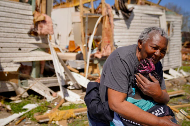 Ester Johnson-El, 62, embraces her great granddaughter She-Keelie, 6, in front of the wreckage of her home after seeing each other for the fist time since the tornado, after a monster storm system tore through the South and Midwest on Friday, in Wynne, Arkansas, U.S. April 1, 2023. (REUTERS)