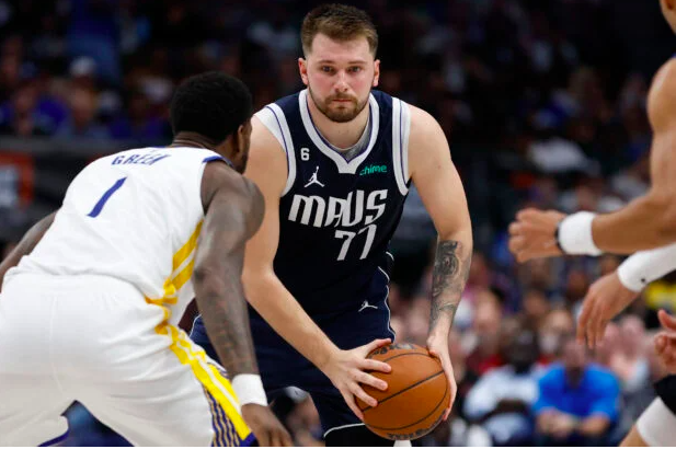 NBA denies Dallas Mavericks’ protest of loss to Golden State Warriors. In this file photo taken on March 22, 2023, Luka Doncic of the Dallas Mavericks looks to pass while defended by JaMychal Green of the Golden State Warriors in the second half at American Airlines Center. (Getty Images/AFP)