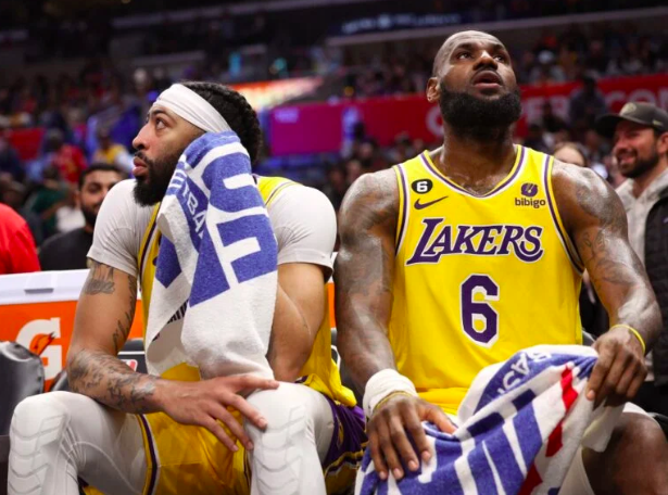 Anthony Davis #3 and LeBron James #6 of the Los Angeles Lakers react from the bench during a 125-118 LA Clippers win at Crypto.com Arena on April 05, 2023 in Los Angeles, California. Harry How/Getty Images/AFP
