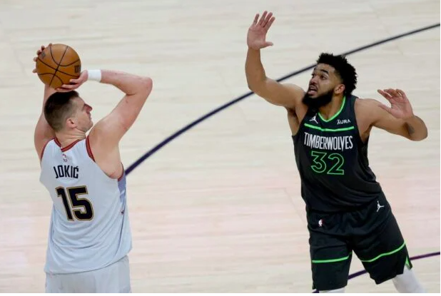 Nikola Jokic #15 of the Denver Nuggets puts up a shot over Karl-Anthony Towns #32 of the Minnesota Timberwolves in the fourth quarter during Round 1 Game 5 of the NBA Playoffs at Ball Arena on April 25, 2023 in Denver, Colorado. ]Matthew Stockman/Getty Images/AFP
