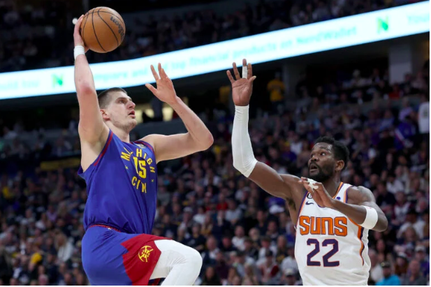 Nikola Jokic  of the Denver Nuggets goes to the basket against Deandre Ayton  of the Phoenix Suns in the first quarter at Ball Arena on April 29, 2023 in Denver, Colorado.  (Getty Images via AFP)