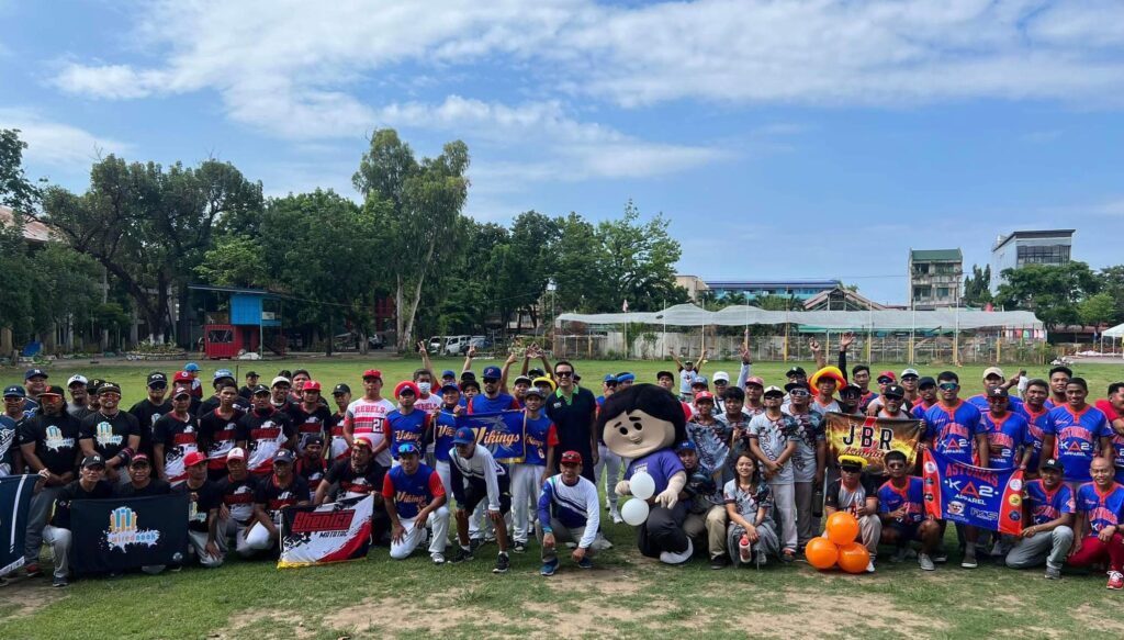 The competing teams and organizers of the first Cong. Edu Rama Softball Cup gather at the center field for a photo during the opening ceremony on Sunday.