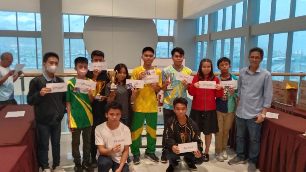 John Dave Lavandero ( in yellow shirt, center) poses with the rest of the winning players of the CCSI U-20 chess tournament at the SM Seaside City Cebu.