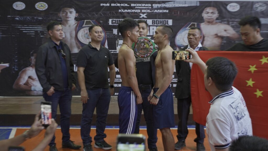 Shane Gentallan (left) and DianXing Zhu (right) engage in a staredown during the weigh-in for their WBC regional bout. | Photo from PMI Bohol Boxing Stable