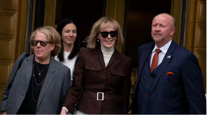 E. Jean Carroll, center, exits federal court in New York on May 9 following the verdict in her civil case against former U.S. President Donald Trump. | Reuters