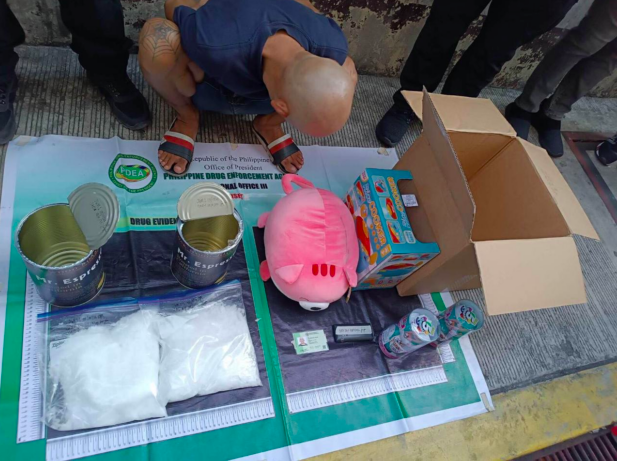 This photo from the Philippine Drug Enforcement Agency shows the consignee-suspect identified as Joel Reyes (a.k.a Kyle Puna Sanchez), 42, and the confiscated crystal meth (locall known as “shabu”) worth P12,240,000.00 that was imported from San Jose City in California, United States. Authorities intercepted the illegal drug at the Port of Clark on Tuesday, May 9, 2023. Then, in a controlled delivery operation, recovered the contraband from the suspect in Barangay Highway Hills, Mandaluyong City on May 11.