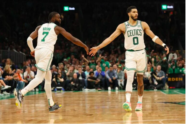 Jaylen Brown #7 high fives Jayson Tatum #0 of the Boston Celtics against the Miami Heat during the fourth quarter in game two of the Eastern Conference Finals at TD Garden on May 19, 2023 in Boston, Massachusetts. Adam Glanzman/Getty Images/AFP